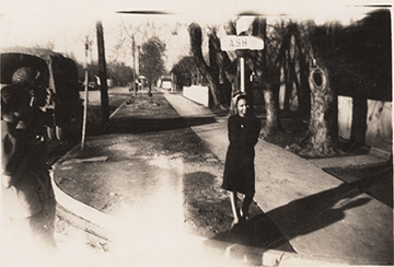 Erma Hayman's daughter, Barbara, stands on corner of Ash Street and Grand Ave in Boise's River Street Neighborhood.